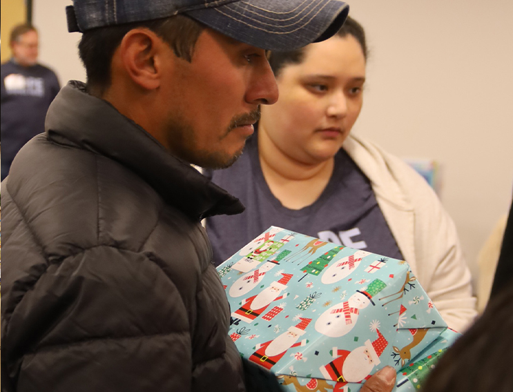 Volunteer holding a wrapped gift