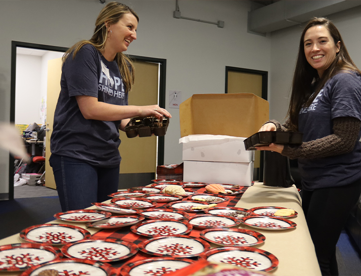 Volunteers setting out plates for food