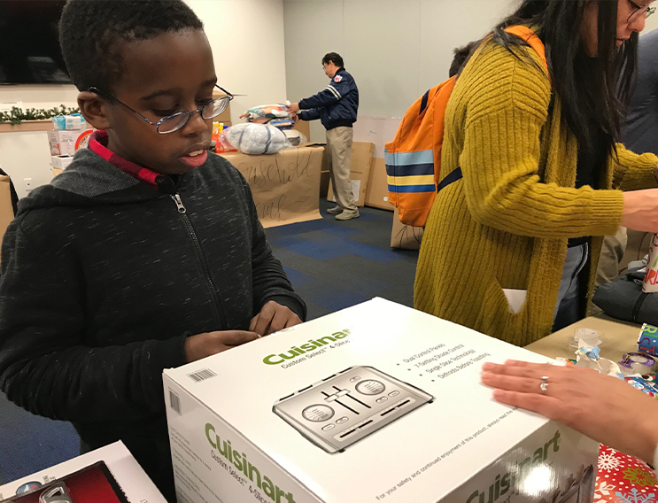 Team member and young volunteer wrapping a toaster