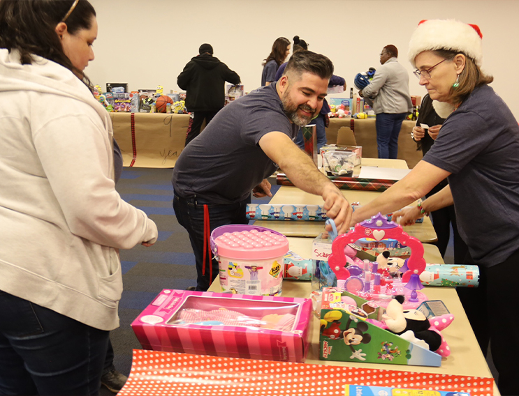 Team member wrapping donated toys for kids