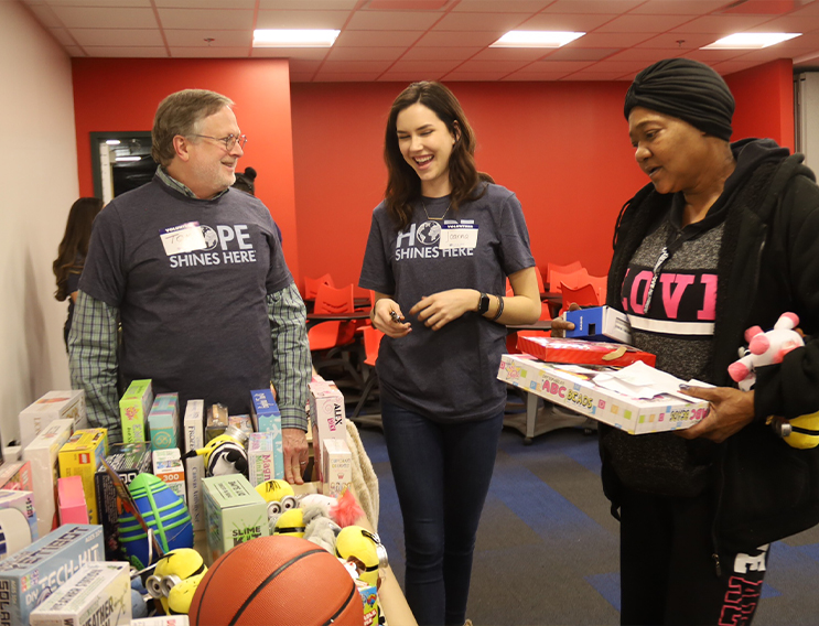 Three volunteers sorting through donations