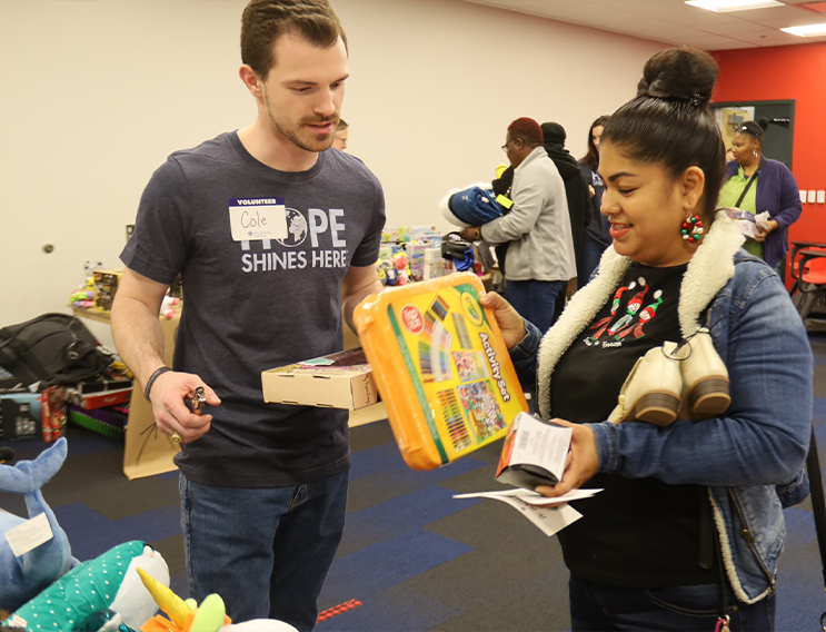 Two volunteers sorting through donated items