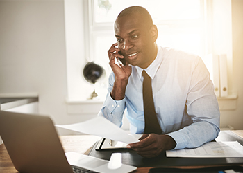 Man on the phone to discuss financial planning differentiators with Irving Texas wealth management team