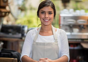 Young business owner smiling in her shop