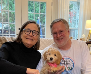 people holding a puppy